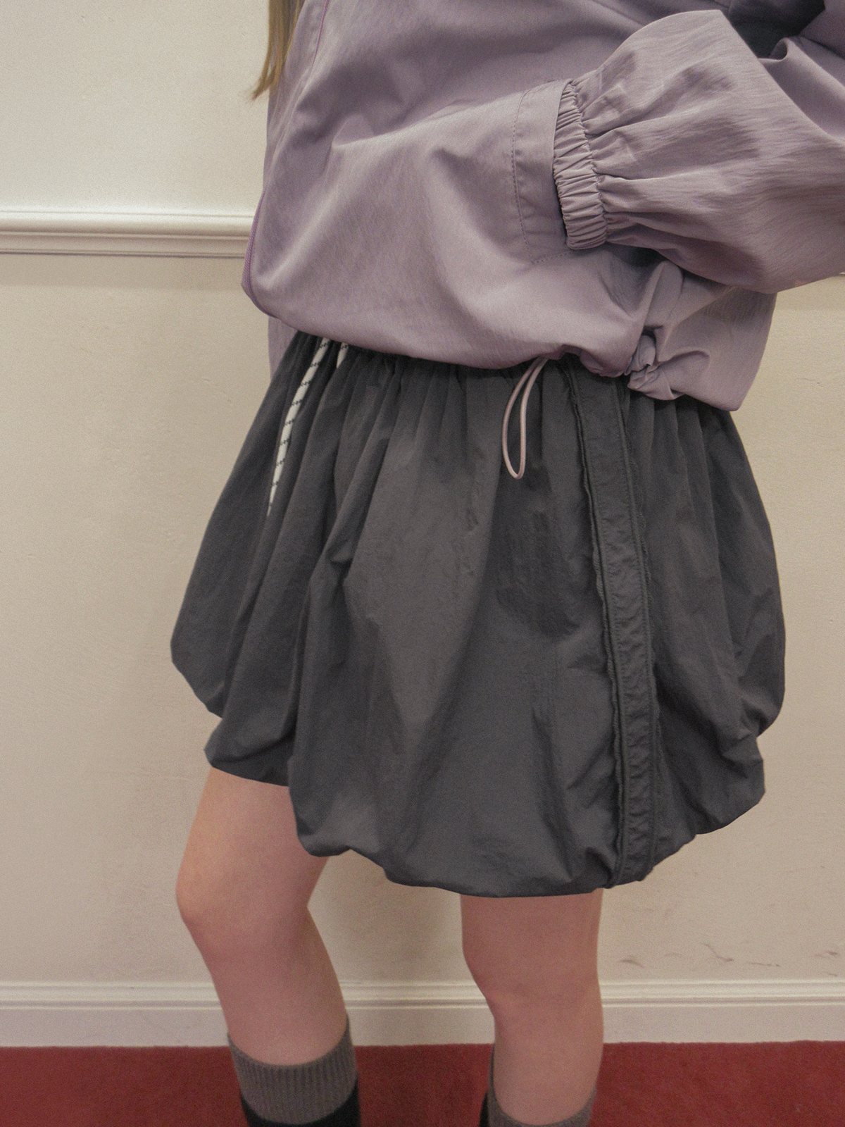 TWEE Colt nylon balloon banding mini skirt - Model styling view