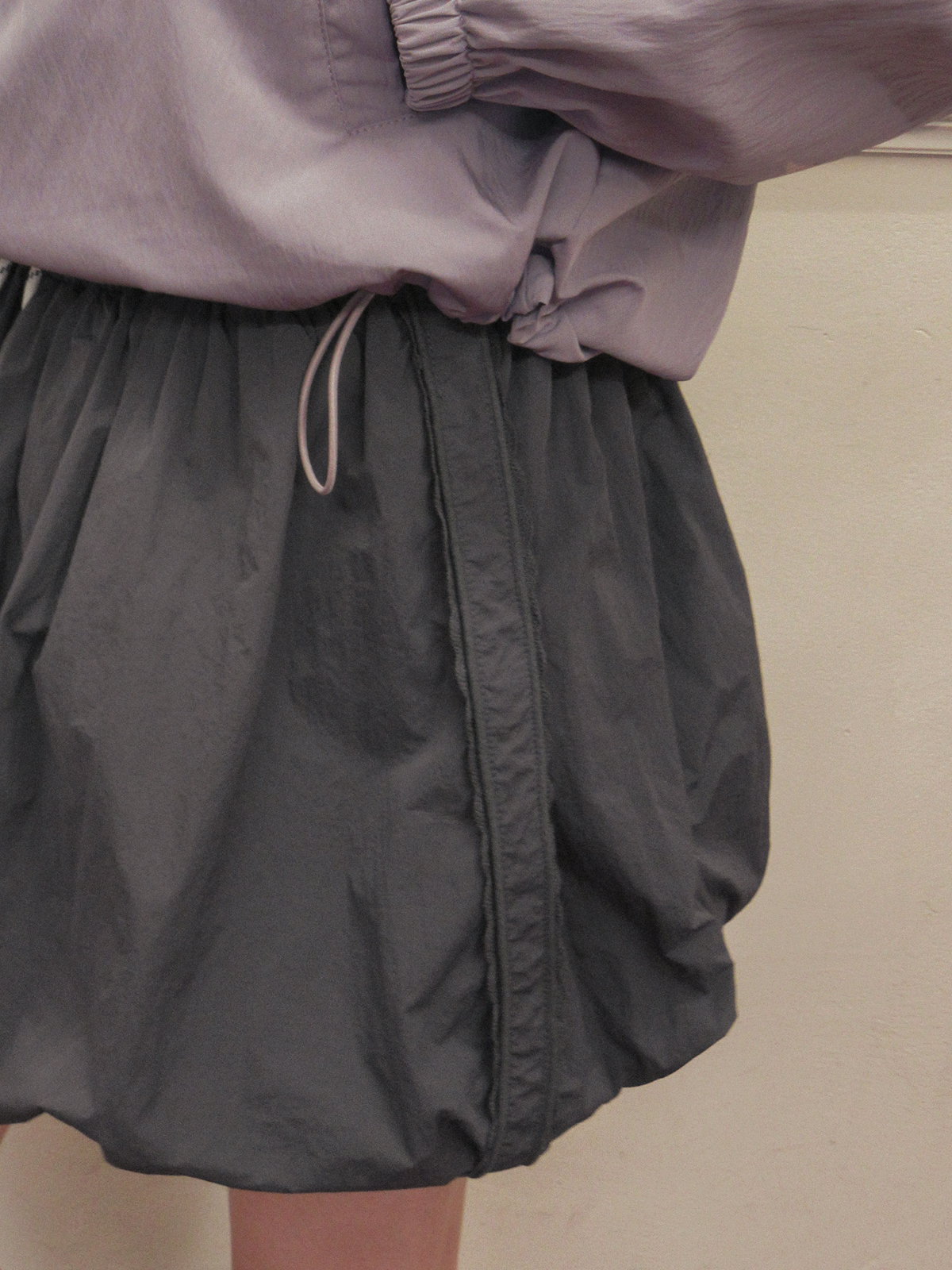 TWEE Colt nylon balloon banding mini skirt - Model styling view